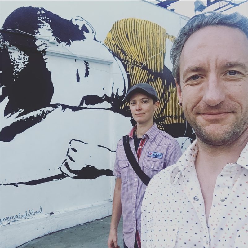 Amy and Gary in front of a mural